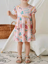 Pale-blush children’s cotton dress with ruffle sleeves and abstract print.