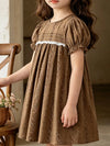 Brown vintage floral puff-sleeve children's dress with lace detail.