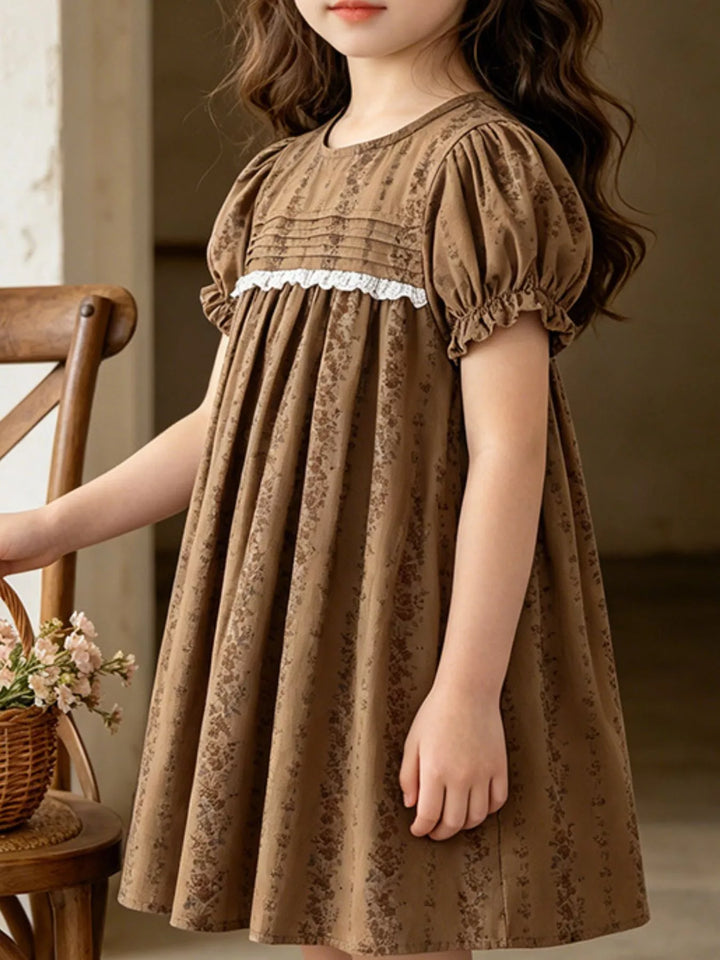 Brown vintage floral puff-sleeve children's dress with lace detail.