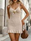 Light khaki knit mini dress with shell embellishment and ruffled hem.