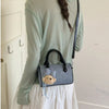 Pastel blue denim barrel crossbody bag