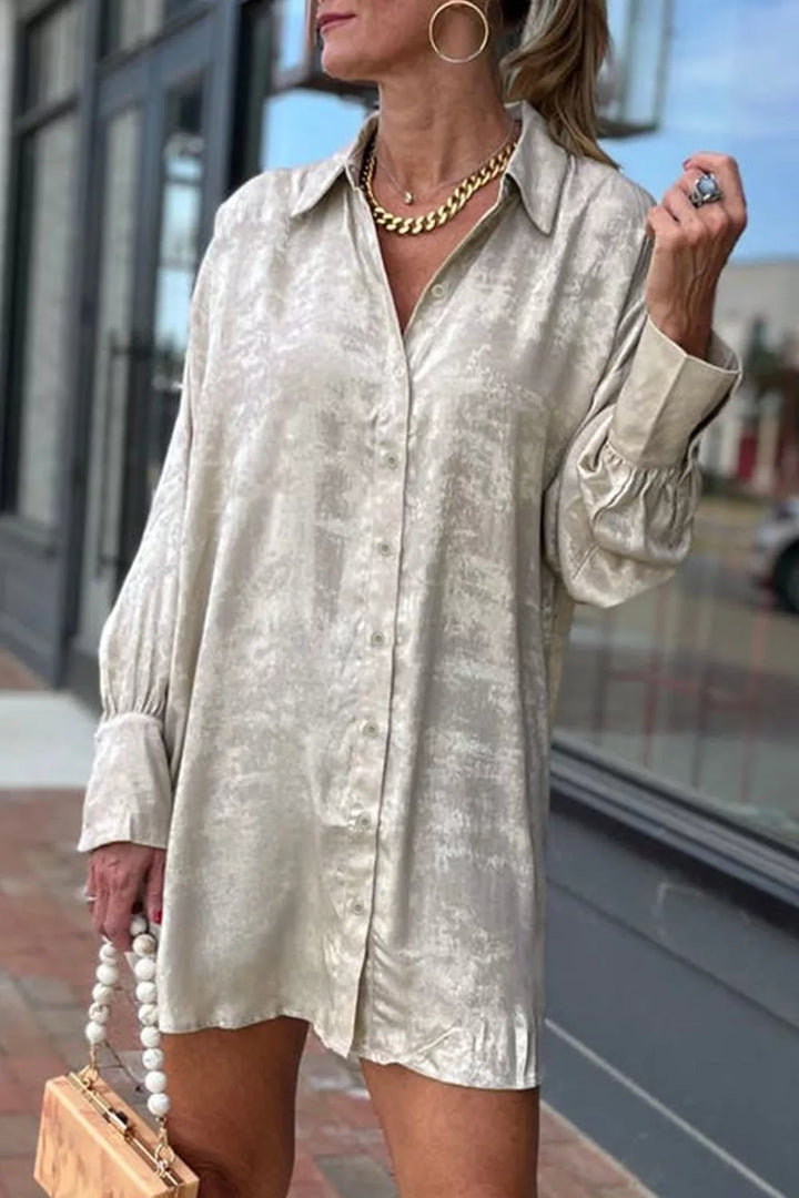 Beige button-front long-sleeve mini shirt dress.