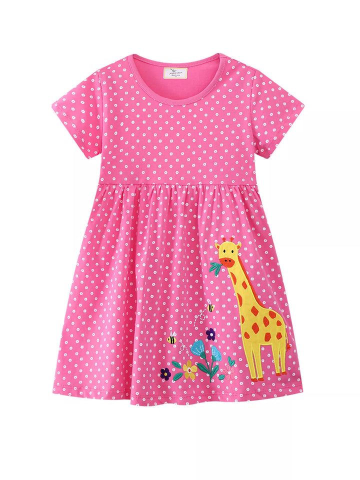 Fuchsia pink children’s dress with giraffe appliqué and white polka dots.