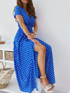 Royal blue polka-dot surplice maxi dress with side slit.