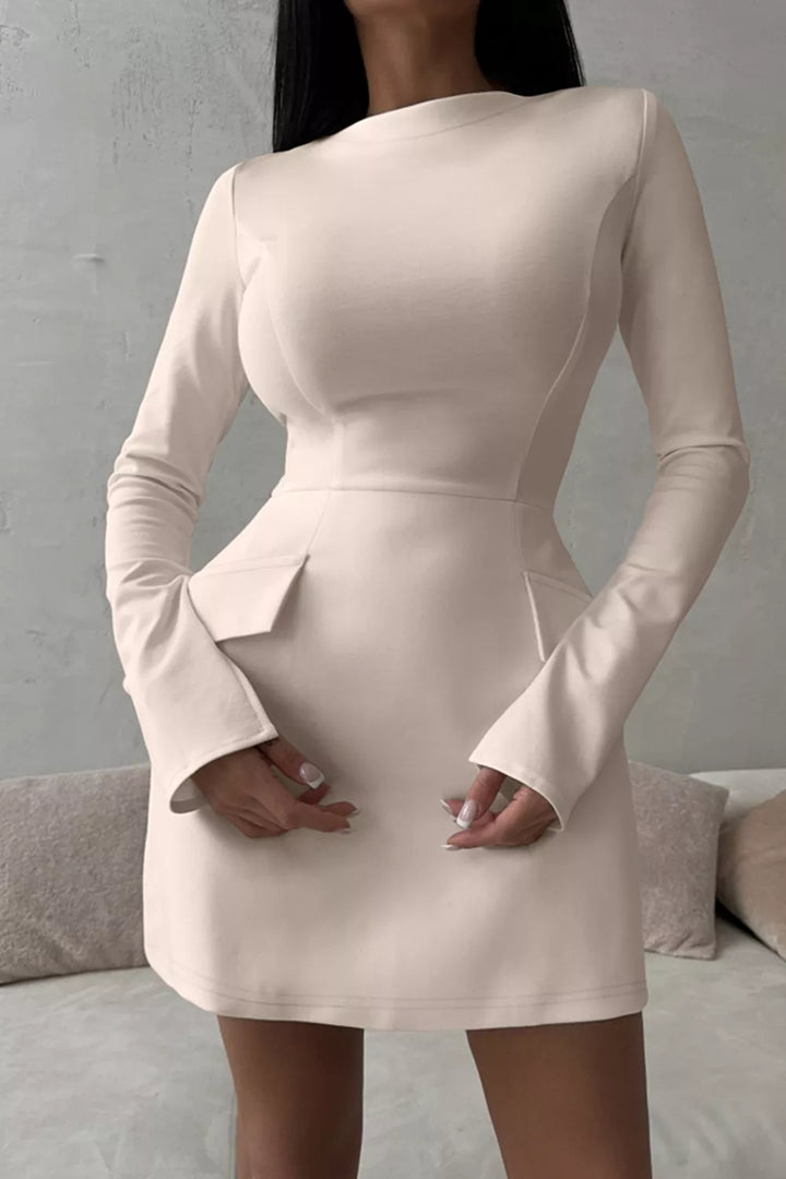 White long-sleeve mini dress with button front and flap pockets.